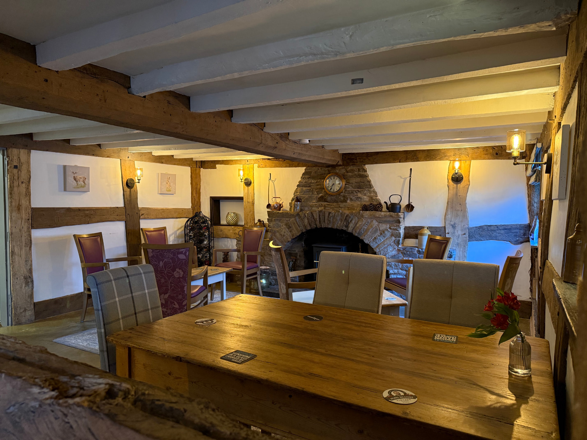Long oak table looking through to the fireside lounge at The Bell Inn